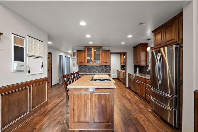 4407 Curve Ave, Edina, MN 55424 - kitchen with appliances with stainless steel finishes, a kitchen island, backsplash, dark wood-style floors, and recessed lighting