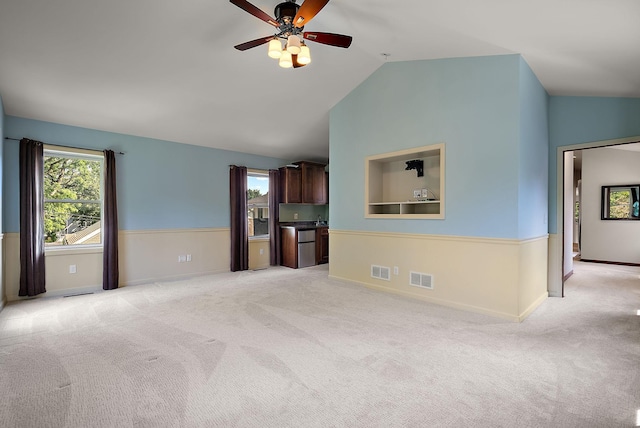 4407 Curve Ave, Edina, MN 55424 - unfurnished living room featuring light carpet, lofted ceiling, and ceiling fan