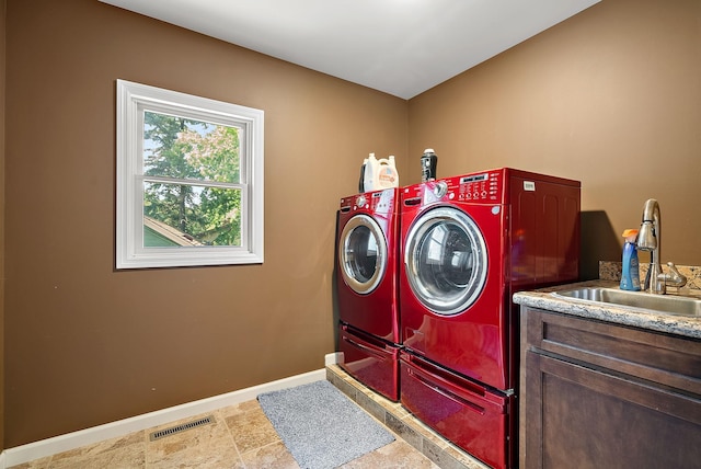 4407 Curve Ave, Edina, MN 55424 - washroom with washing machine and dryer, cabinet space, and stone finish flooring