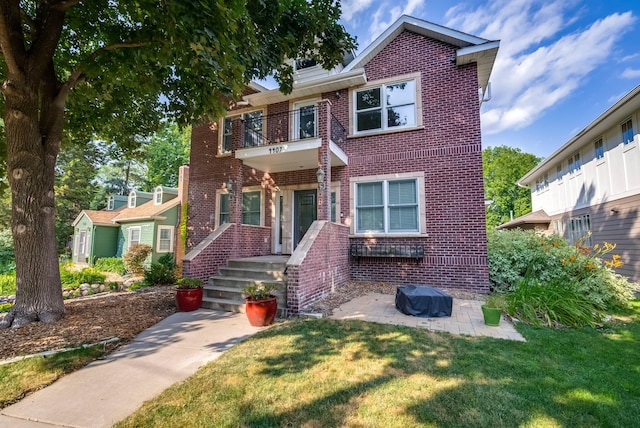 4407 Curve Ave, Edina, MN 55424 - view of front of property with brick siding, a balcony, a front lawn, and a patio area