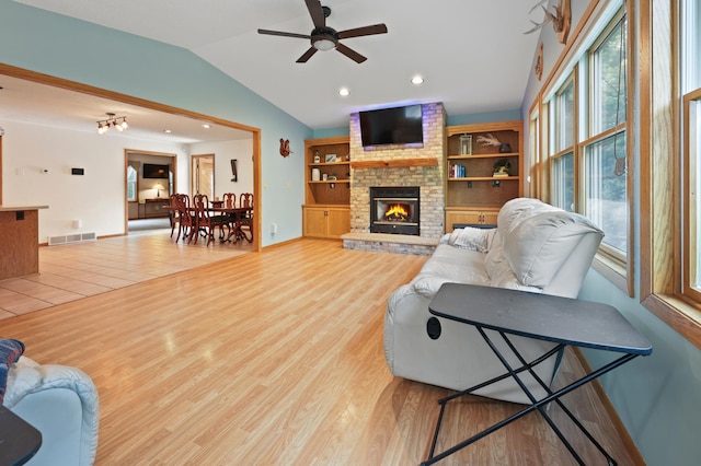 5100 16th St NE, Minden Twp, MN 56379 - living area featuring lofted ceiling, a ceiling fan, a brick fireplace, light wood finished floors, and recessed lighting