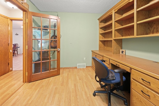 5100 16th St NE, Minden Twp, MN 56379 - office space featuring built in study area, light wood-style flooring, and a textured ceiling