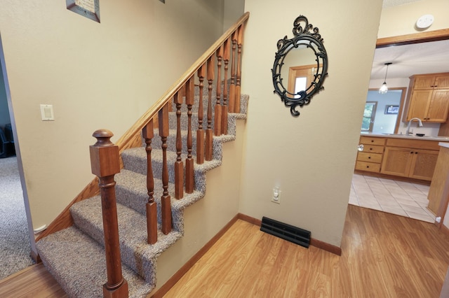 5100 16th St NE, Minden Twp, MN 56379 - staircase featuring wood finished floors