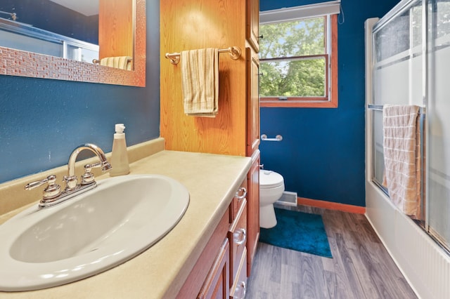 5100 16th St NE, Minden Twp, MN 56379 - bathroom with vanity, shower / bath combination with glass door, and wood finished floors