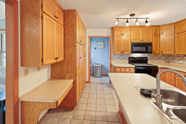 5100 16th St NE, Minden Twp, MN 56379 - kitchen with black appliances, light countertops, light tile patterned floors, decorative backsplash, and a textured ceiling