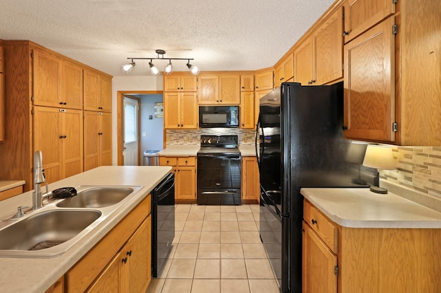 5100 16th St NE, Minden Twp, MN 56379 - kitchen featuring black appliances, decorative backsplash, light countertops, and a textured ceiling