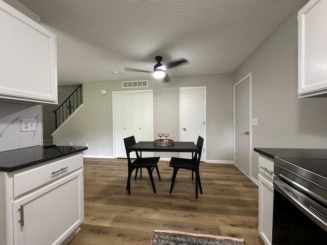 12619 Alder St NW, Coon Rapids, MN 55448 - dining room with ceiling fan, stairway, wood finished floors, and a textured ceiling