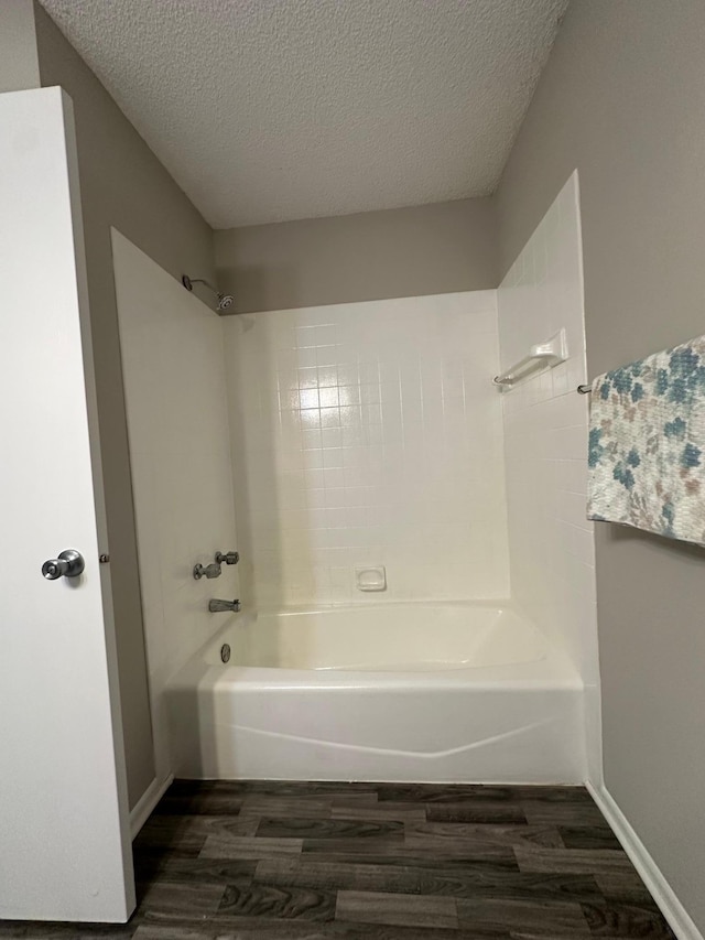 12619 Alder St NW, Coon Rapids, MN 55448 - full bath featuring wood finished floors, tub / shower combination, and a textured ceiling