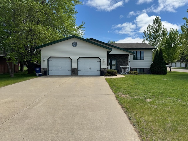 1420 4th St SW, Wadena, MN 56482 - tri-level home featuring a garage, a front yard, driveway, and stone siding