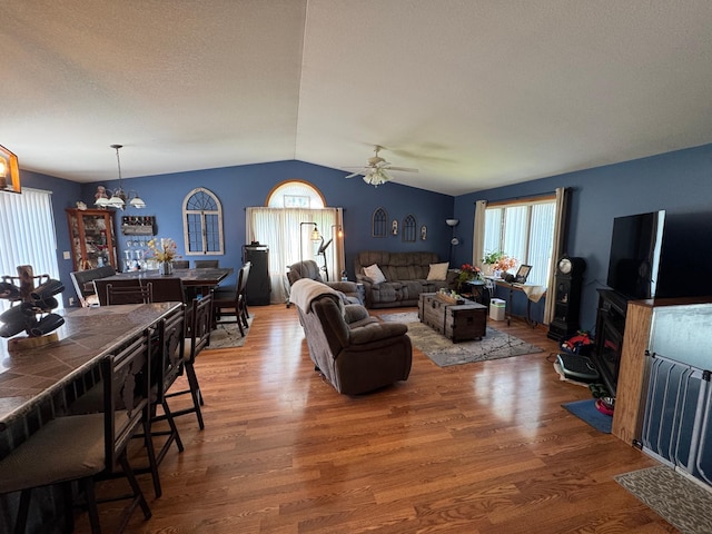 1420 4th St SW, Wadena, MN 56482 - living area featuring lofted ceiling, wood finished floors, a ceiling fan, and a chandelier
