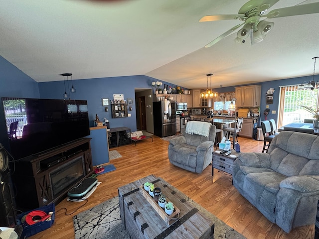 1420 4th St SW, Wadena, MN 56482 - living area with a chandelier, lofted ceiling, ceiling fan, healthy amount of natural light, and light wood finished floors