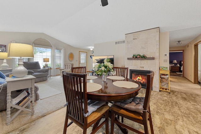114 Oxford Path, Mankato, MN 56001 - dining room featuring vaulted ceiling, a tile fireplace, and light carpet