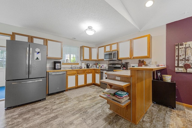 114 Oxford Path, Mankato, MN 56001 - kitchen with appliances with stainless steel finishes, a peninsula, light wood finished floors, light countertops, and a textured ceiling