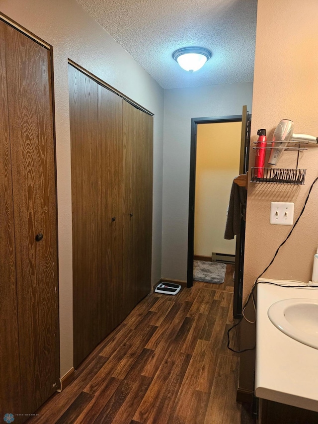 311 Prairiewood Cir S Unit 307, Fargo, ND 58103 - laundry area featuring dark wood-style flooring and a textured ceiling