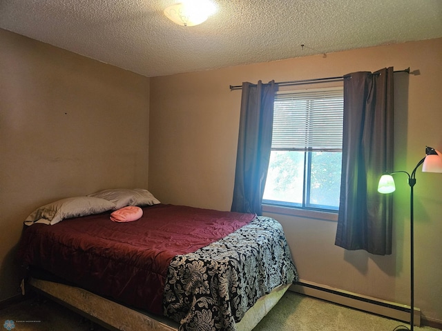 311 Prairiewood Cir S Unit 307, Fargo, ND 58103 - bedroom with a baseboard heating unit, carpet floors, and a textured ceiling