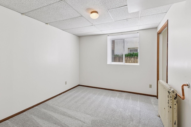 1108 16th Ave SE, Minneapolis, MN 55414 - empty room featuring radiator heating unit, carpet floors, and a drop ceiling