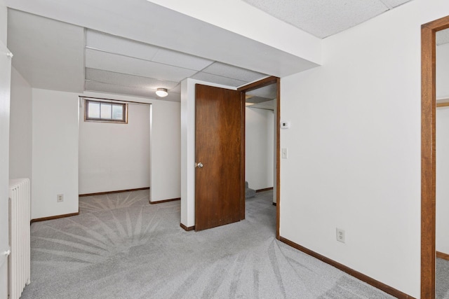 1108 16th Ave SE, Minneapolis, MN 55414 - below grade area featuring radiator heating unit, carpet floors, and a paneled ceiling