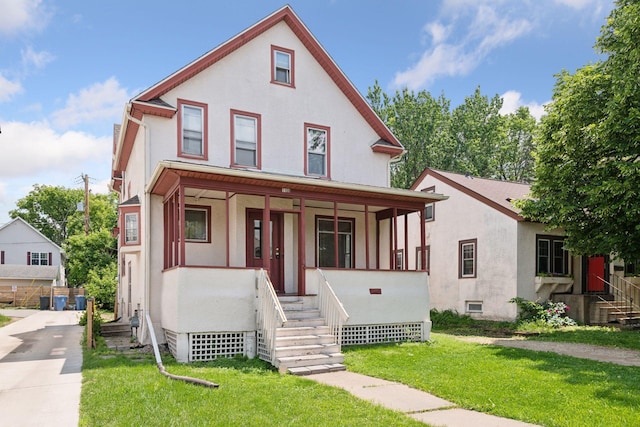 1108 16th Ave SE, Minneapolis, MN 55414 - view of front of home featuring a porch, stucco siding, and a front lawn