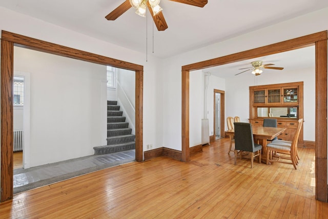 1108 16th Ave SE, Minneapolis, MN 55414 - dining space with a ceiling fan, radiator, stairs, and light wood finished floors