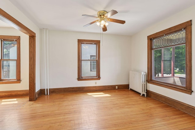 1108 16th Ave SE, Minneapolis, MN 55414 - spare room with radiator, light wood finished floors, and ceiling fan