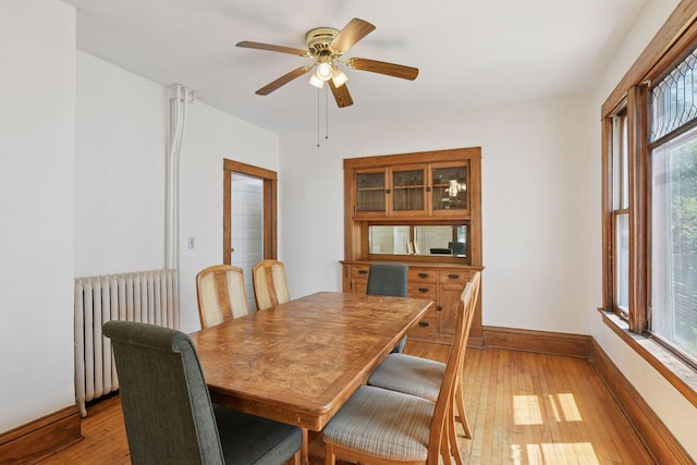 1108 16th Ave SE, Minneapolis, MN 55414 - dining area with radiator heating unit, light wood-style floors, a ceiling fan, and healthy amount of natural light