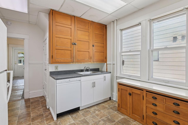 1108 16th Ave SE, Minneapolis, MN 55414 - kitchen featuring white dishwasher, plenty of natural light, a drop ceiling, stone finish floors, and brown cabinetry