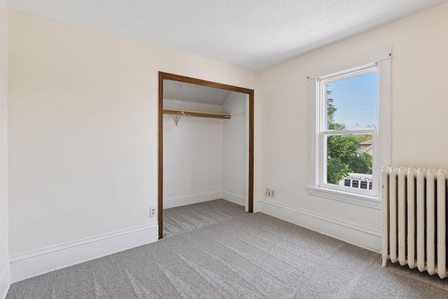 1108 16th Ave SE, Minneapolis, MN 55414 - unfurnished bedroom featuring radiator, carpet floors, and a closet
