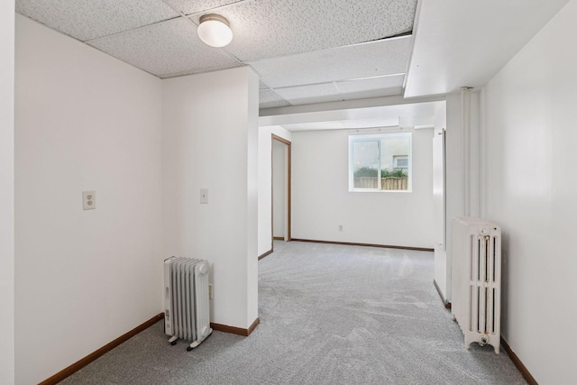 1108 16th Ave SE, Minneapolis, MN 55414 - unfurnished room featuring radiator, carpet, and a drop ceiling
