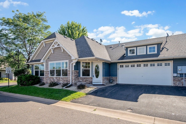 4715 Wyngate Blvd, Forest Lake, MN 55025 - craftsman-style house with stone siding, driveway, roof with shingles, and a garage
