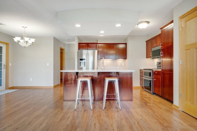 4715 Wyngate Blvd, Forest Lake, MN 55025 - kitchen featuring stainless steel appliances, a chandelier, light wood-type flooring, light countertops, and recessed lighting