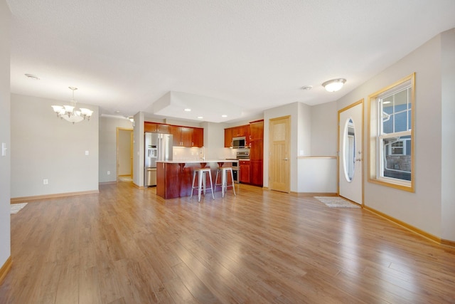 4715 Wyngate Blvd, Forest Lake, MN 55025 - kitchen with stainless steel appliances, open floor plan, a chandelier, a kitchen breakfast bar, and recessed lighting