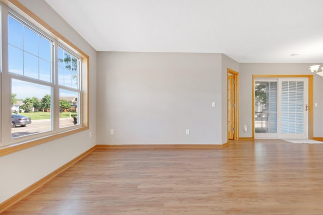 4715 Wyngate Blvd, Forest Lake, MN 55025 - empty room with light wood-style flooring and a chandelier