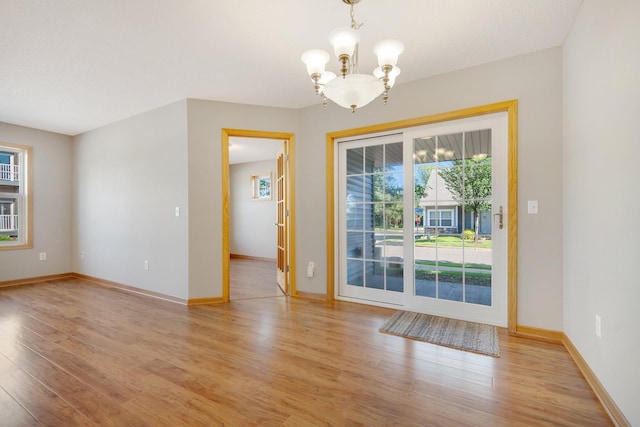 4715 Wyngate Blvd, Forest Lake, MN 55025 - unfurnished room with a chandelier, plenty of natural light, and light wood finished floors