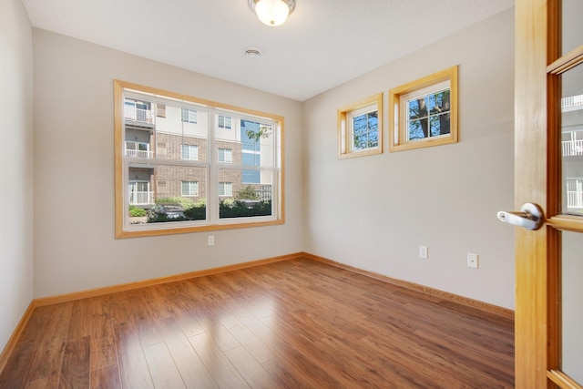 4715 Wyngate Blvd, Forest Lake, MN 55025 - unfurnished room featuring wood finished floors and baseboards