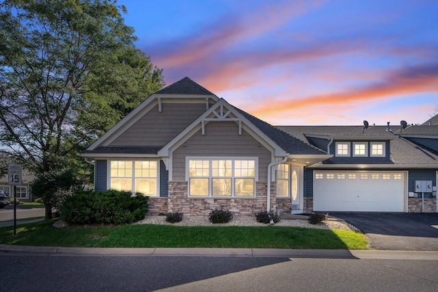 4715 Wyngate Blvd, Forest Lake, MN 55025 - view of front facade featuring driveway, stone siding, and a garage