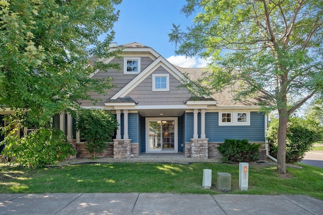 4715 Wyngate Blvd, Forest Lake, MN 55025 - view of front of home featuring a front lawn, stone siding, and covered porch