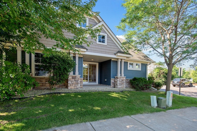 4715 Wyngate Blvd, Forest Lake, MN 55025 - view of front of home with a front yard, stone siding, and a porch
