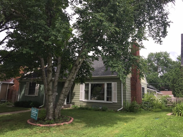 5505 Morgan Ave S, Minneapolis, MN 55419 - view of front of property with a chimney, a front lawn, and roof with shingles