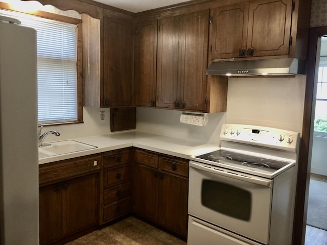 5505 Morgan Ave S, Minneapolis, MN 55419 - kitchen featuring white electric range, under cabinet range hood, and light countertops
