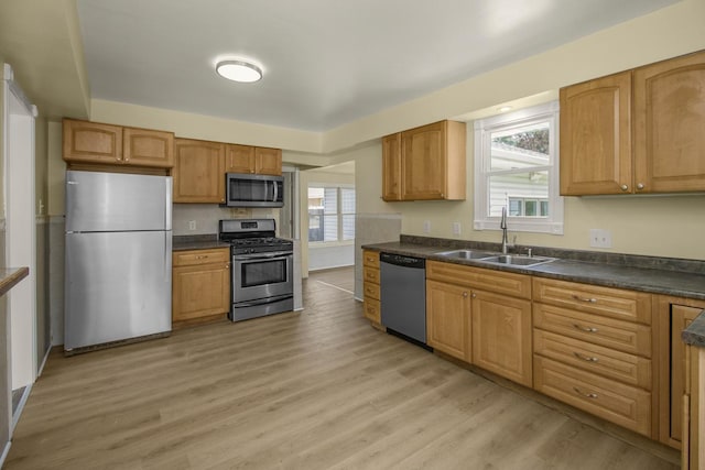4700 Xerxes Ave N, Minneapolis, MN 55430 - kitchen with appliances with stainless steel finishes, dark countertops, and light wood-style flooring