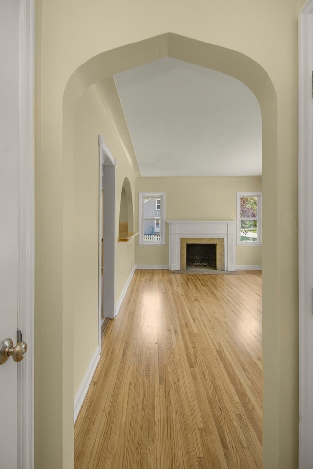 4700 Xerxes Ave N, Minneapolis, MN 55430 - unfurnished living room with arched walkways, light wood-style floors, and a fireplace