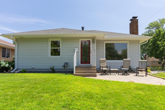 4700 Xerxes Ave N, Minneapolis, MN 55430 - rear view of property featuring a lawn, a patio area, a chimney, and roof with shingles
