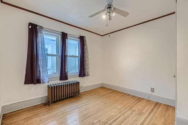 2810 Morgan Ave N, Minneapolis, MN 55411 - empty room with radiator heating unit, light wood-style floors, ornamental molding, and ceiling fan