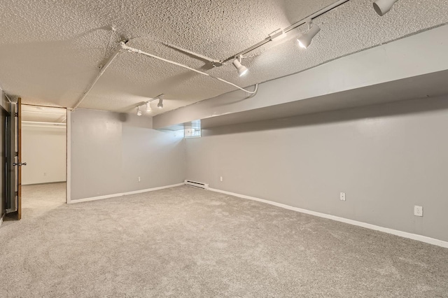 2810 Morgan Ave N, Minneapolis, MN 55411 - finished below grade area featuring rail lighting, a baseboard heating unit, a textured ceiling, and carpet