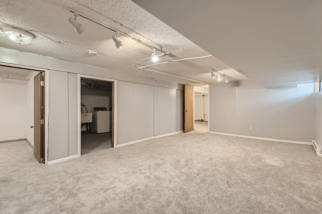 2810 Morgan Ave N, Minneapolis, MN 55411 - finished below grade area with rail lighting, washer / dryer, carpet, a textured ceiling, and a baseboard radiator