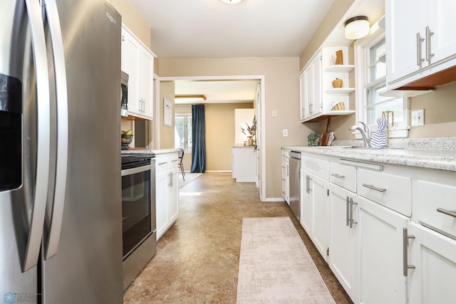 414 21st Ave N, Fargo, ND 58102 - kitchen featuring appliances with stainless steel finishes, open shelves, white cabinets, concrete floors, and light stone countertops