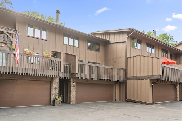 2671 Sumac Rdg, White Bear Lake, MN 55110 - rear view of house featuring board and batten siding and an attached garage