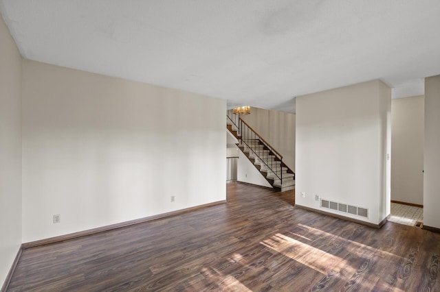 2671 Sumac Rdg, White Bear Lake, MN 55110 - empty room with dark wood-style flooring, stairs, and a chandelier