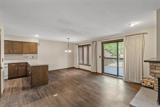 2671 Sumac Rdg, White Bear Lake, MN 55110 - kitchen with dark wood-type flooring, light countertops, a peninsula, pendant lighting, and a chandelier