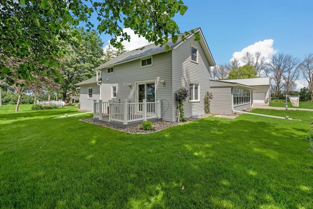 3820 8th St, Owatonna, MN 55060 - rear view of house with a yard, a wooden deck, and a detached garage